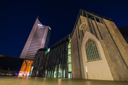 Leipzig, Germany - July 02, 2022: City center at night. The new Paulinum of the University of Leipzig, stands at the site of the old university church. Behind it the city Hochhaus (city skyscraper)のeditorial素材