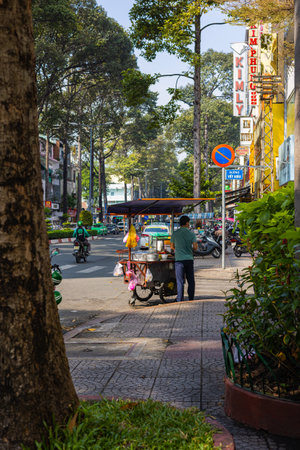 Ho Chi Minh City, Vietnam - November 10, 2022: Street food seller on the streets of Saigon....