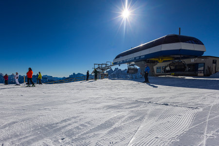 Falcade, Italy - February 15, 2023: At a lift station in the mountains of the Dolomites. Skiers wait in line to take the cable car. Queue of skiers to the lift in ski resort, a lot of people.のeditorial素材