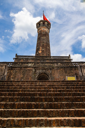 Hanoi, Vietnam - May 28, 2023: Vietnam Military History Museum and the Hanoi flag tower. 33 meters high tower features three tiers and a pyramidal peak with the large national flag on a flag pole.のeditorial素材