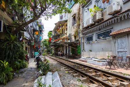 Hanoi, Vietnam - May 28, 2023: Train Street in Hanoi is a narrow, bustling lane with tracks. Close knit houses, adorned with plants, are inches away from passing trains. bars and cafes line the trackのeditorial素材