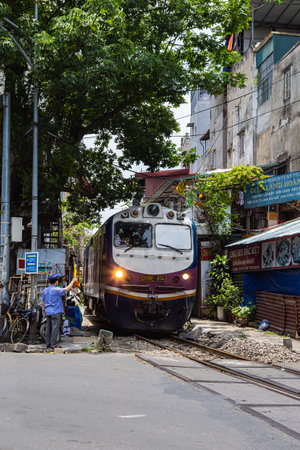 Hanoi, Vietnam - May 28, 2023: Train Street in Hanoi is a narrow, bustling lane with tracks. Close knit houses, adorned with plants, are inches away from passing trains. bars and cafes line the trackのeditorial素材
