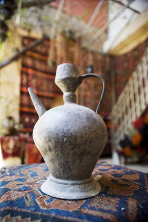 Bronze ewer in an arab shop with colorful backgroundの写真素材