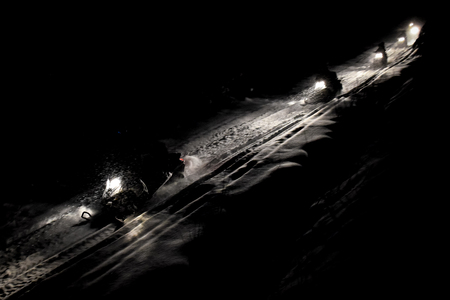 Snow mobile in blizzard through the woods and forestの写真素材