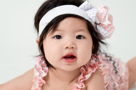 baby girl with cute floral dress and white backgroundの写真素材