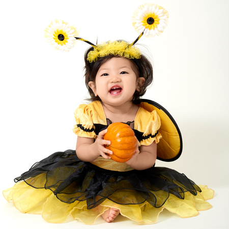 Baby wearing bee costume is ready for Halloweenの写真素材