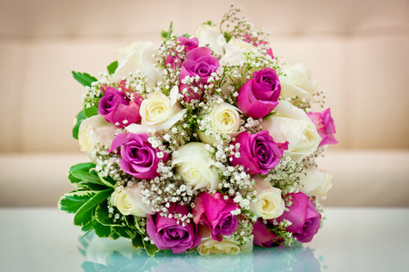 Wedding flower bouquet for the bride in white and purple rosesの写真素材