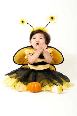 Baby wearing bee costume is ready for Halloweenの写真素材