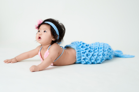 baby girl with cute mermaid outfit and white backgroundの写真素材