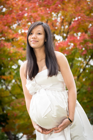Pregnant lady in the fall season maternity photoの写真素材
