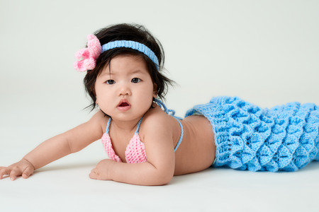 baby girl with cute mermaid outfit and white backgroundの写真素材