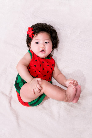 baby girl with cute watermelon outfit and white backgroundの写真素材
