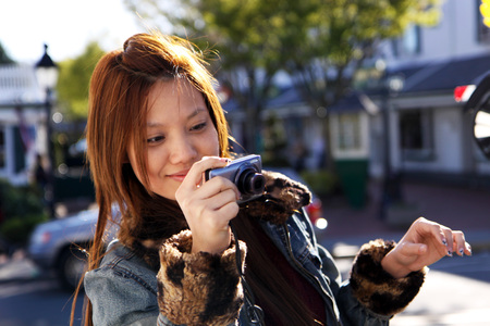 Asian long hair girl taking photo with cameraの写真素材