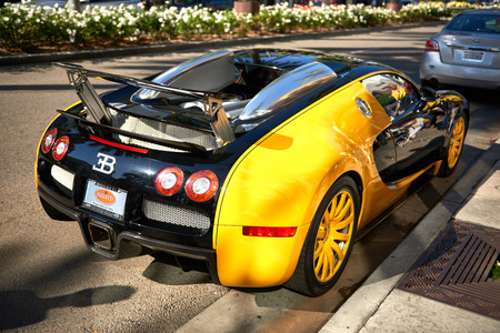 Yellow Bugatti Veyron parked on Rodeo Drive of Beverly Hills by dealership to attract tourists on Nov 2016.のeditorial素材