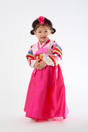 Smile Korean little girl wearing a Traditional Hanbok dress in white backgroundの写真素材