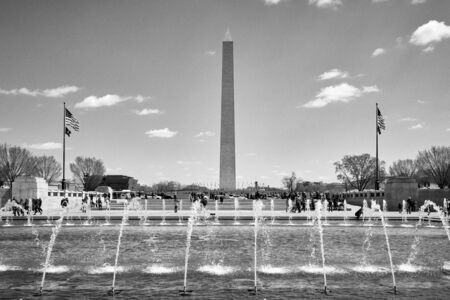Washington DC, USA - April 2018: Washington Monument view from the World World II Memorial fountain in black and white.のeditorial素材