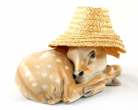 A decorative figure of a laying deer in a hat.の写真素材