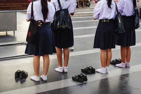 Schoolgirls at Ganesha-shrine in front of CentralWorld - shopping mall in Bangkok, Thailand, Asiaのeditorial素材