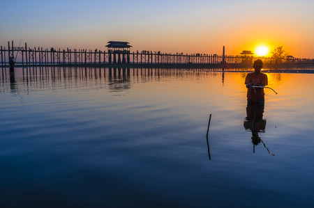 Fisher in front of U Bein Bridge during Sunset, Amarapura, Myanmar, Asiaのeditorial素材