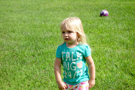 Girl with Soccer Ball on fieldの写真素材