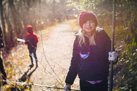 Beautiful young girl hiking outside in winterの写真素材