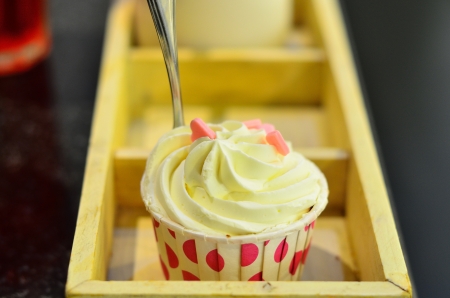 Vanilla cupcake and spoon on the wood boxの写真素材
