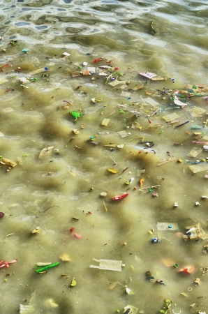 trash floating in the riverの写真素材