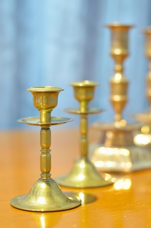 four golden candlestick laying on the tableの写真素材