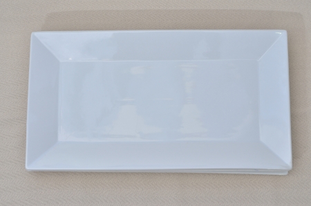 an empty rectangle white dish on a table linenの写真素材