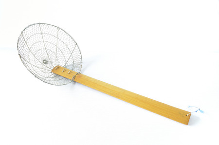 big traditional steel wire mesh noodle wood handle on isolated backgroundの写真素材