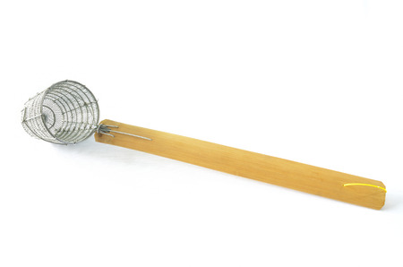 small traditional steel wire mesh noodle wood handle on isolated backgroundの写真素材