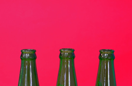 close up three bottleneck on isolated red backgroundの写真素材
