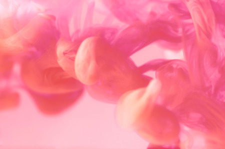 pink color movement in a water on pink backgroundの写真素材