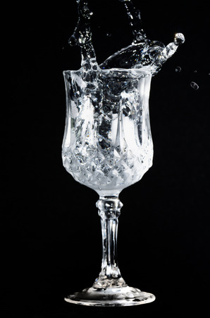 water splash in glass on black backgroundの写真素材