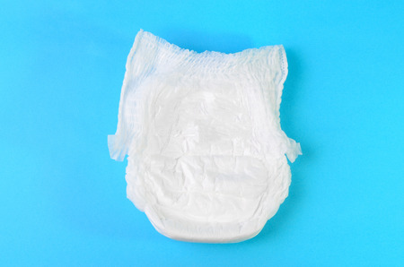 baby diapers on light blue background