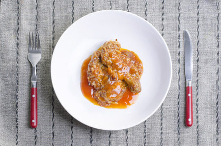 fried chicken with chilli sauce in white dish on silver naperyの写真素材