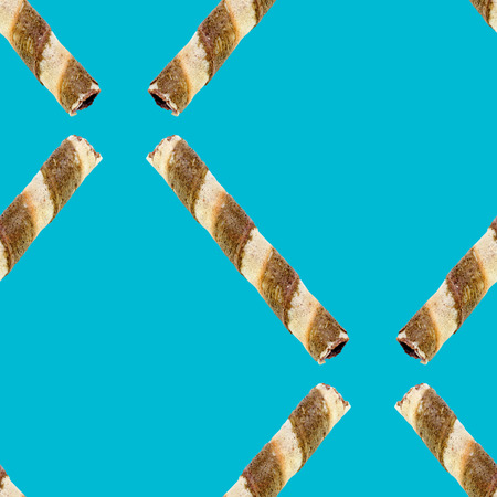 the wafer stick with chocolate flavoured cream seamless pattern on light blueの写真素材