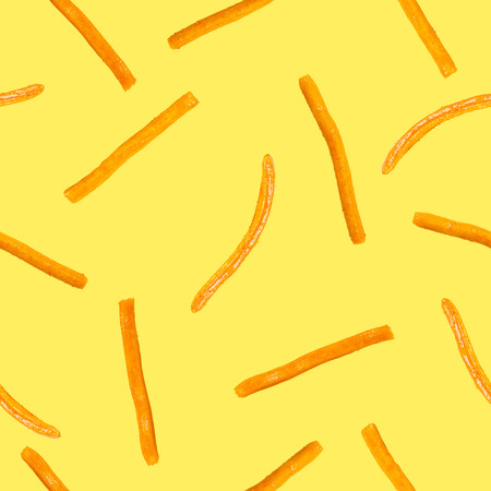the crispy seasoned stick biscuit seamless pattern on yellowの写真素材