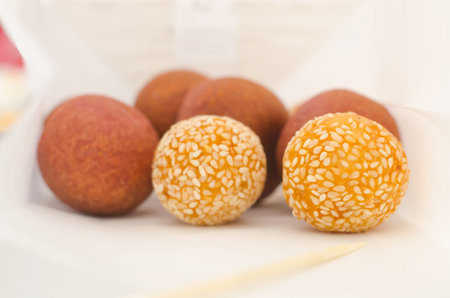 thai fried sweet potato sesame and taro balls in paper bag