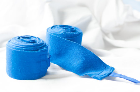 blue boxing hand wraps on white cloth background.の写真素材