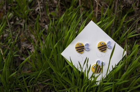 postal with bees on a green grass