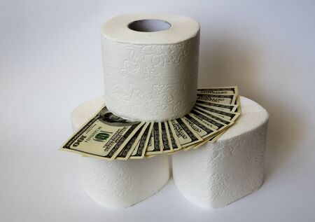 toilet paper and dollars on a white backgroundの写真素材