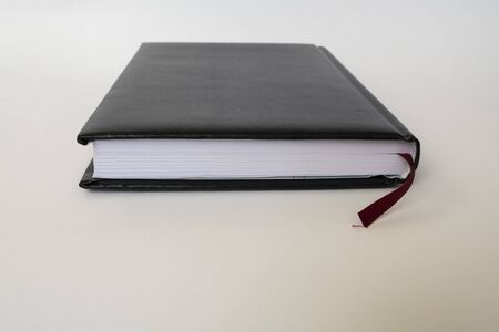 Black leather notebook on white background
