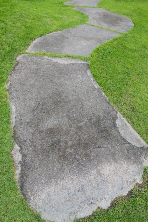 cement walk path with green grassの写真素材