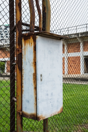 Rusty electric control box on the tennis courtの写真素材