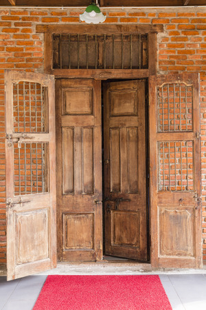 Open the ancient wooden door on the brick wallの写真素材