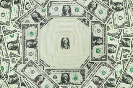 A pile of one dollar bill hangs over each other as texture and backgroundの写真素材