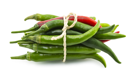 Chili peppers tied by rope on white backgroundの写真素材