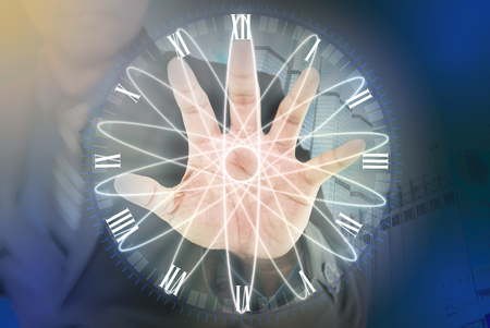 Businessman hands are touching the clock face without a clock hands, concept of no timeの写真素材