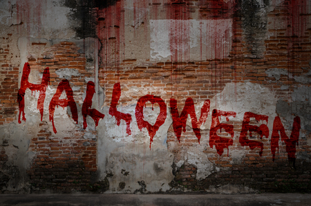 Write a Halloween message on bloody background scary old brick wall, concept of Halloween and horror crimeの写真素材